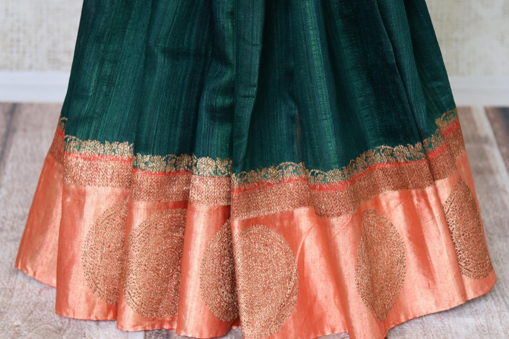 Buy dark green tussar Benarasi saree online in USA with red zari border. Be an epitome of elegance in exquisite Banarasi saris from Pure Elegance Indian clothing store in USA.-pleats