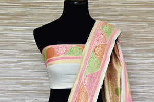 Buy cream georgette Banarasi sari online in USA with colorful zari border. Make your ethnic wardrobe colorful and rich with a splendid collection of Banarasi sarees from Pure Elegance Indian clothing store in USA. Shop online.-pleats