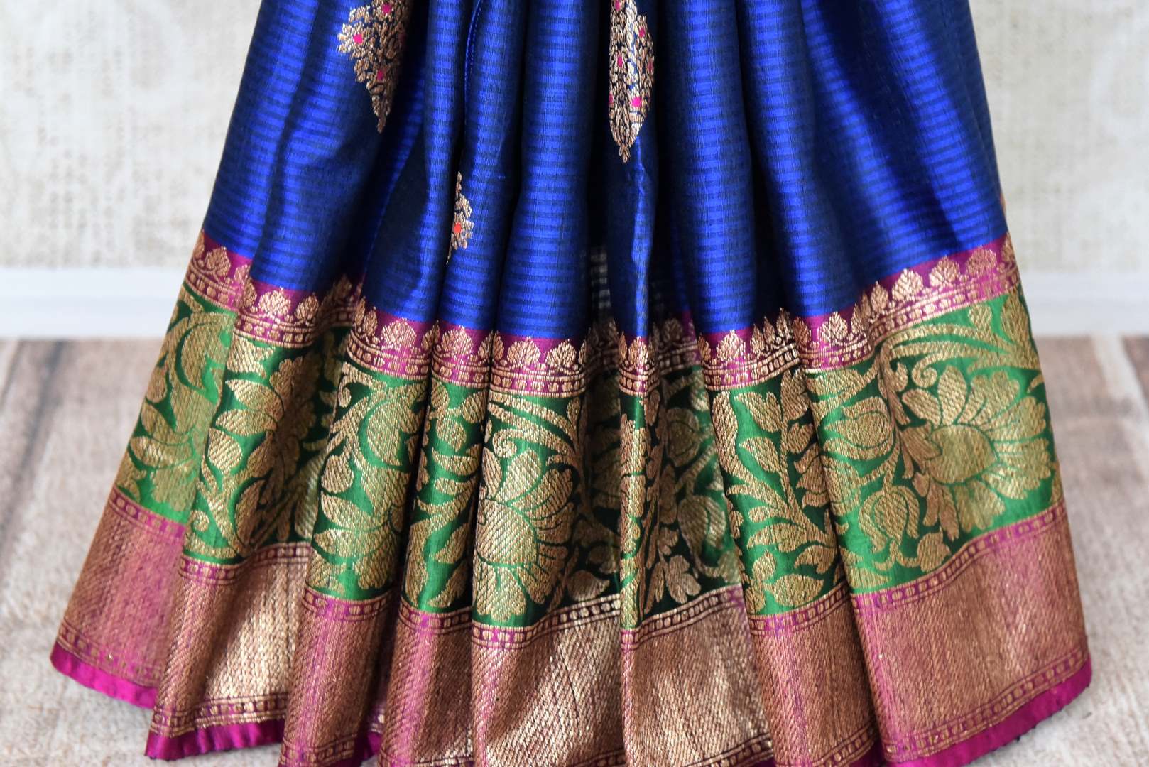 Buy blue striped tussar Benarasi saree online in USA with zari buta and purple and green antique zari border. Shine bright in best of Indian designer sarees from Pure Elegance Indian fashion store in USA on special occasions. Choose from a splendid variety of Banarasi sarees, pure handwoven saris. Shop online.-pleats