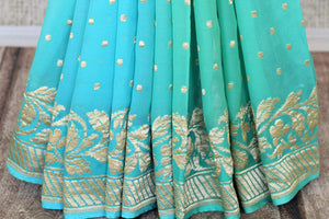 Buy traditional red georgette Banarasi sari online in USA with zari work. Feel traditional on special occasions in beautiful Indian designer saris from Pure Elegance Indian fashion store in USA. Choose from a splendid variety of Banarasi sarees, pure handwoven saris. Buy online.-pleats
