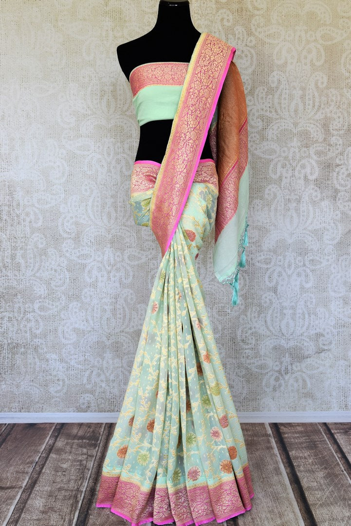 Shop pista green georgette Banarasi saree online in USA with pink zari border. Feel traditional on special occasions in beautiful Indian designer saris from Pure Elegance Indian fashion store in USA. Choose from a splendid variety of Banarasi sarees, pure handwoven saris. Buy online.-full view