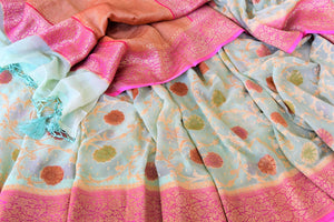 Shop pista green georgette Banarasi saree online in USA with pink zari border. Feel traditional on special occasions in beautiful Indian designer saris from Pure Elegance Indian fashion store in USA. Choose from a splendid variety of Banarasi sarees, pure handwoven saris. Buy online.-details