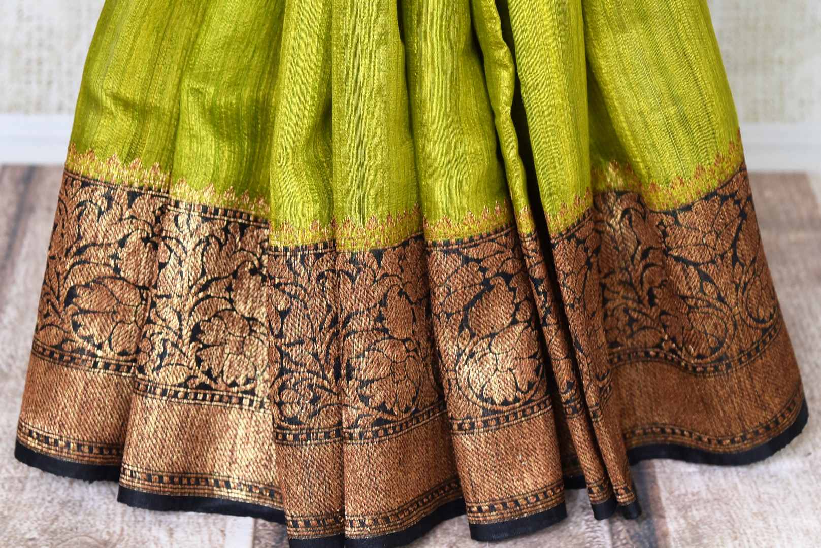 Buy lime green color tussar Benarasi saree online in USA with black zari border. Be an epitome of elegance in exquisite Banarasi saris from Pure Elegance Indian clothing store in USA.-pleats
