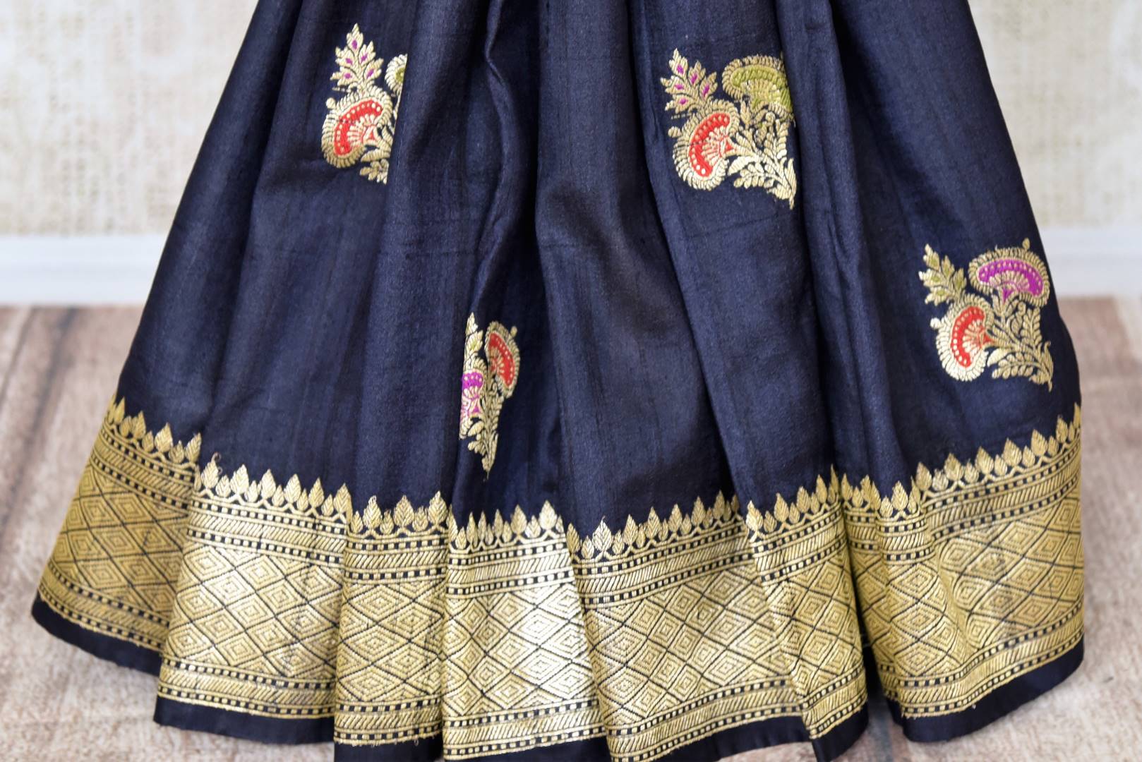 Buy black khaddi Banarasi saree online in USA with zari minakari floral buta. Feel traditional on special occasions in beautiful Indian designer saris from Pure Elegance Indian fashion store in USA. Choose from a splendid variety of Banarasi sarees, pure handwoven saris. Buy online.-pleats