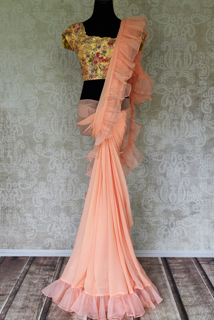 Buy peach ruffled georgette saree online in USA with embroidered yellow saree blouse. Update your saree wardrobe with stunning Indian designer sarees from Pure Elegance Indian fashion store in USA. Shop now.-full view