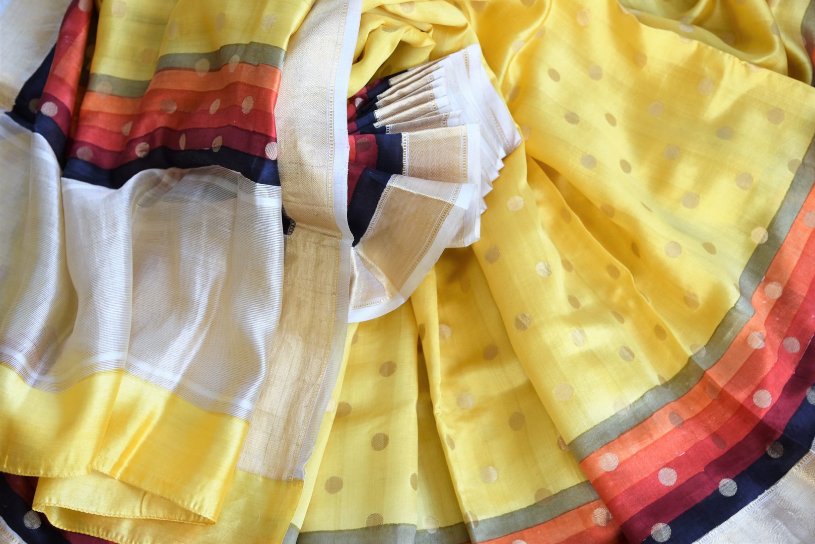 Shop bright yellow zari buta muga silk sari online in USA with multicolor zari border. Stand amongst the crowd with your tasteful ethnic style in beautiful handwoven silk sarees from Pure Elegance Indian fashion store for Indian women in USA.-details