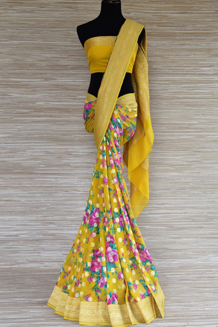 Buy bright yellow floral georgette Banarasi sari online in USA with zari border. Radiate traditional charm with beautiful Banarasi sarees from Pure Elegance Indian clothing store in USA. Choose from a variety of Banarasi silk sarees, Banarasi georgette sarees, Banarasi tussar saris for special occasions.-full view