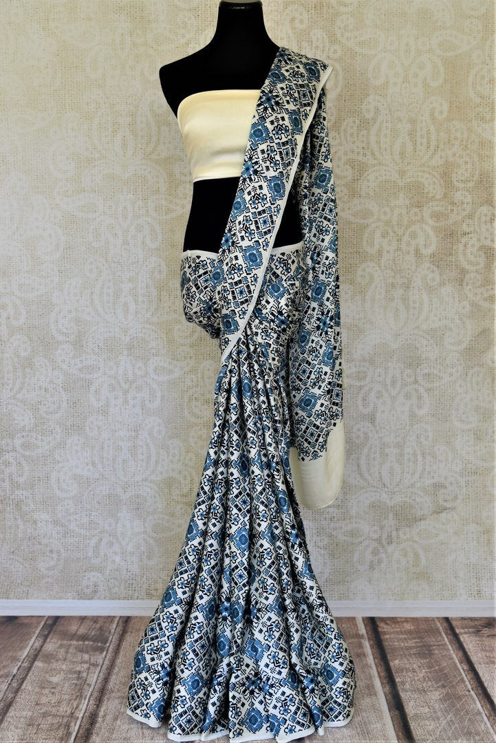 Buy elegant cream and blue printed crepe silk sari online in USA. Be the center of attraction at parties and weddings with exquisite designer saris, print sarees, Bollywood sarees from Pure Elegance Indian fashion store in USA.-full view