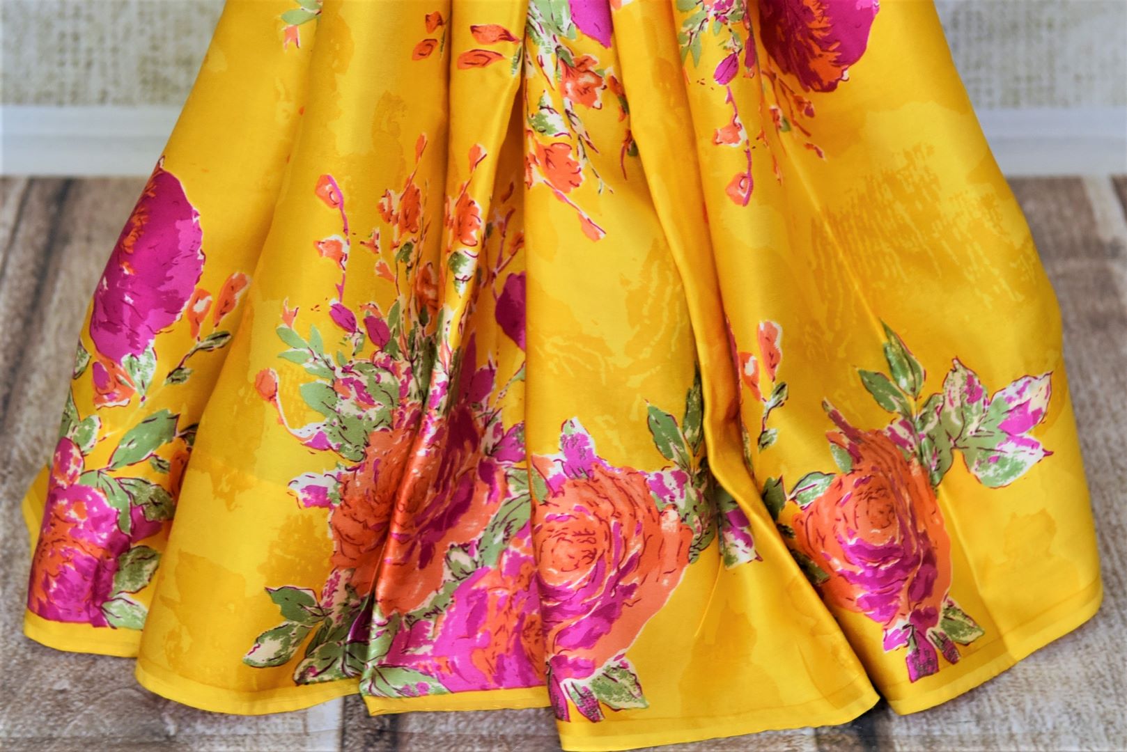 Shop beautiful yellow crepe silk saree online in USA with pink floral print. Be the center of attraction at parties and weddings with exquisite designer sarees, print sarees, Bollywood sarees from Pure Elegance Indian fashion store in USA.-pleats