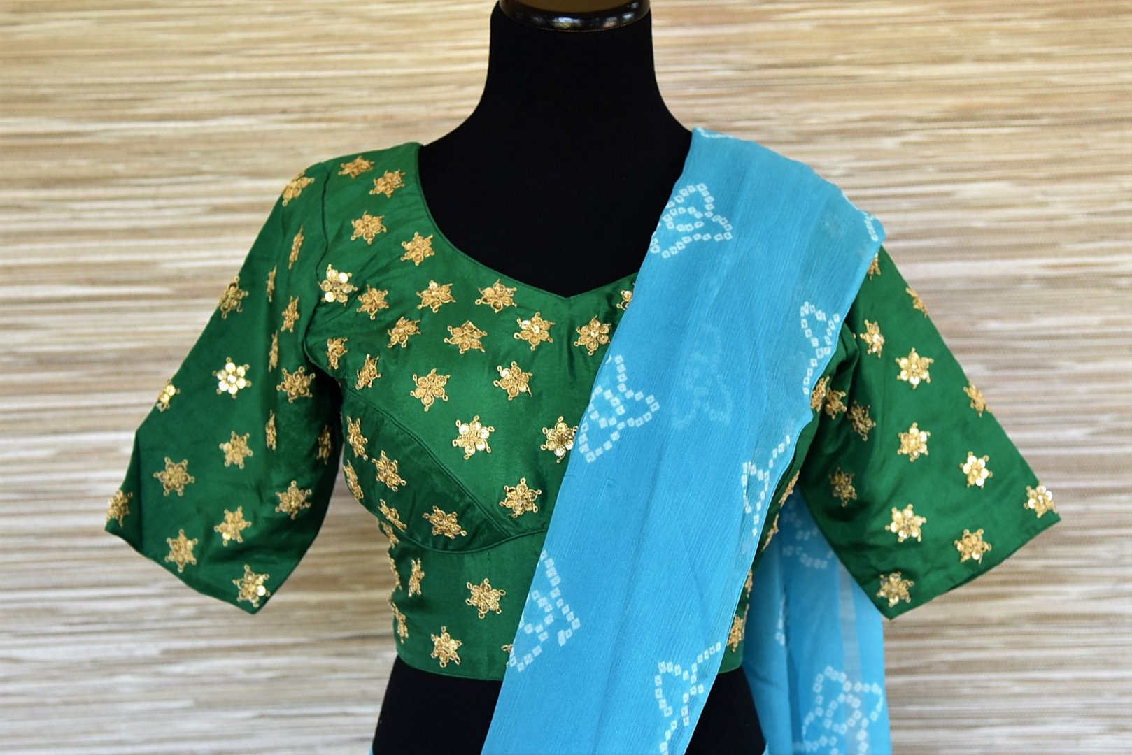 Shop elegant sky blue Bandhej chiffon saree online in USA with embroidered green saree blouse. Be an epitome of elegance and tradition in exquisite designer saris, handwoven saris from Pure Elegance clothing store in USA. -blouse pallu