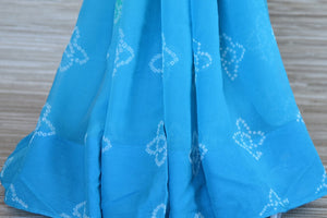 Shop elegant sky blue Bandhej chiffon saree online in USA with embroidered green saree blouse. Be an epitome of elegance and tradition in exquisite designer saris, handwoven saris from Pure Elegance clothing store in USA. -pleats