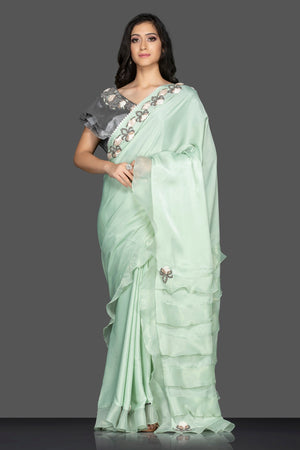 Shop lovely pastel green ruffle sari online in USA with grey embroidered saree blouse. Keep your ethnic fashion on point with exquisite designer sarees, partywear sarees, embroidered sarees from Pure Elegance Indian fashion boutique in USA.-front