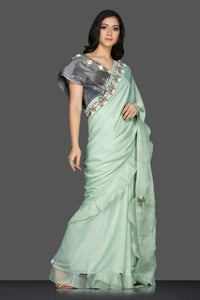 Shop lovely pastel green ruffle sari online in USA with grey embroidered saree blouse. Keep your ethnic fashion on point with exquisite designer sarees, partywear sarees, embroidered sarees from Pure Elegance Indian fashion boutique in USA.-full view