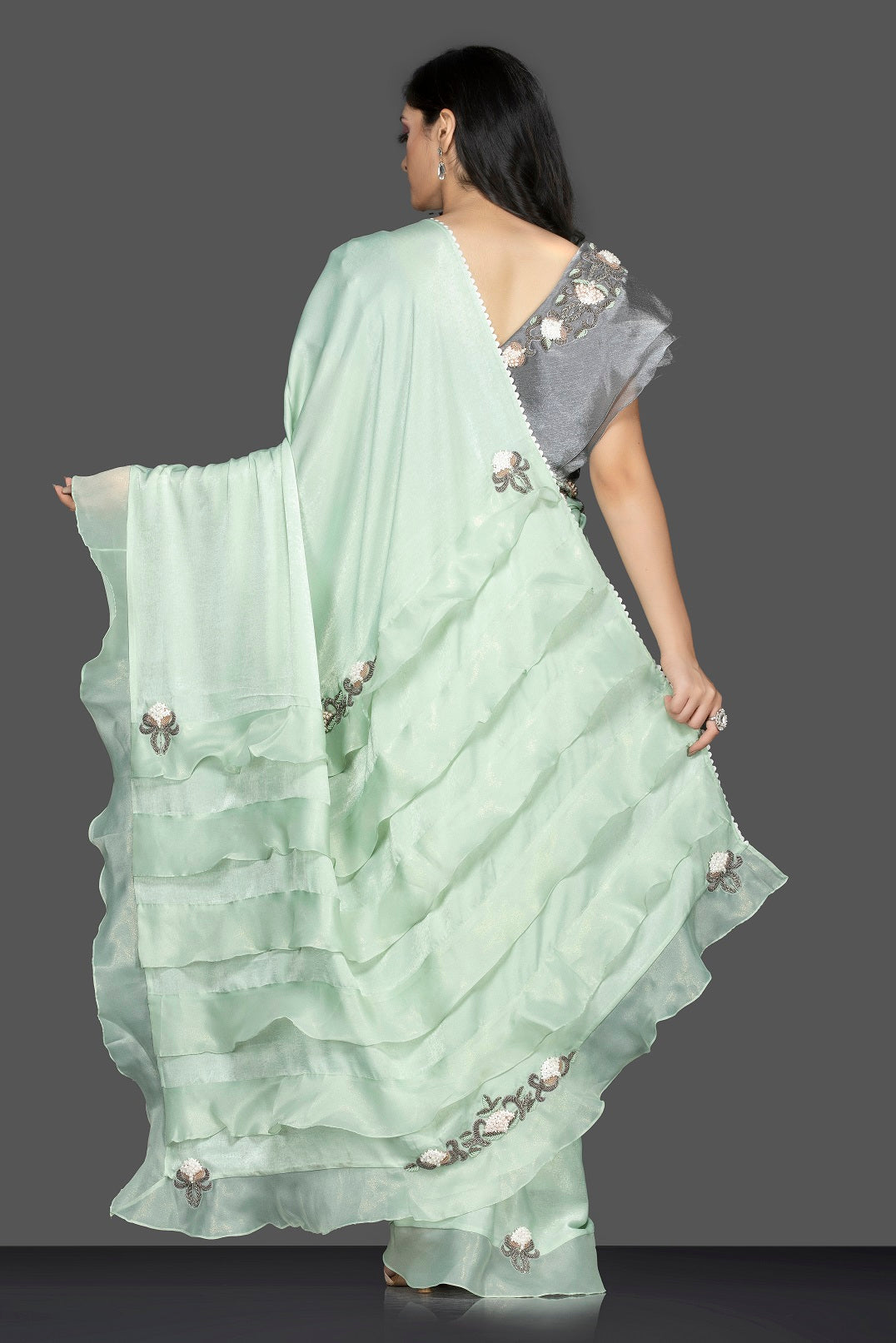 Shop lovely pastel green ruffle sari online in USA with grey embroidered saree blouse. Keep your ethnic fashion on point with exquisite designer sarees, partywear sarees, embroidered sarees from Pure Elegance Indian fashion boutique in USA.-back