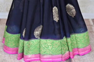 Shop gorgeous black organza Banarasi sari online in USA with green foliate zari border and zari buta. Make your saree wardrobe rich and colorful with stunning handwoven sarees, pure silk sarees, designer sarees from Pure Elegance Indian clothing store in USA.-pleats