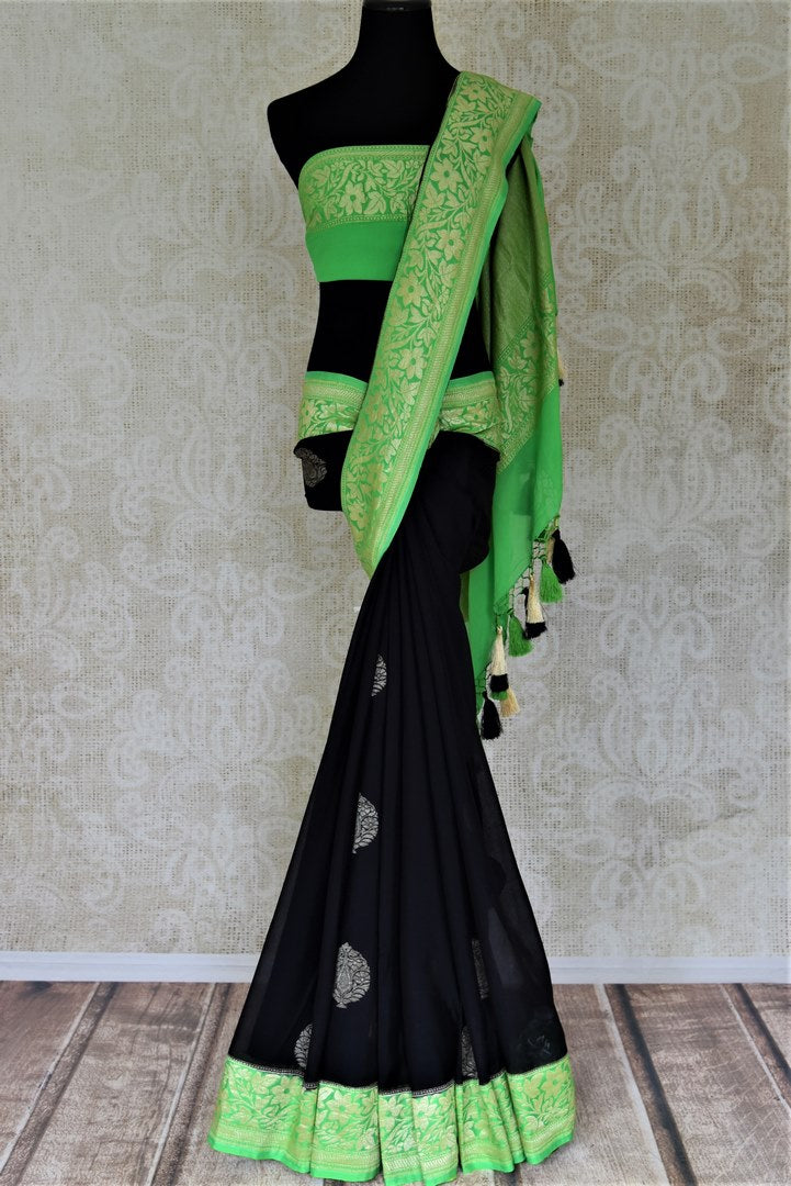 Buy elegant black georgette Banarasi saree online in USA with green foliate zari border. Go for an extraordinary traditional look with splendid handwoven sarees, embroidered sarees with blouses, Banarasi saris from Pure Elegance from Indian cloth store in USA.  Shop online or visit our store now.-full view