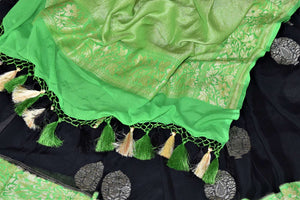 Buy elegant black georgette Banarasi saree online in USA with green foliate zari border. Go for an extraordinary traditional look with splendid handwoven sarees, embroidered sarees with blouses, Banarasi saris from Pure Elegance from Indian cloth store in USA.  Shop online or visit our store now.-details