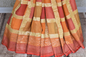 Buy lovely orange and pink zari check georgette Banarasi sari online in USA. Go for an extraordinary traditional look with splendid handwoven sarees, embroidered sarees with blouses, Banarasi saris from Pure Elegance from Indian cloth store in USA.  Shop online or visit our store now.-pleats