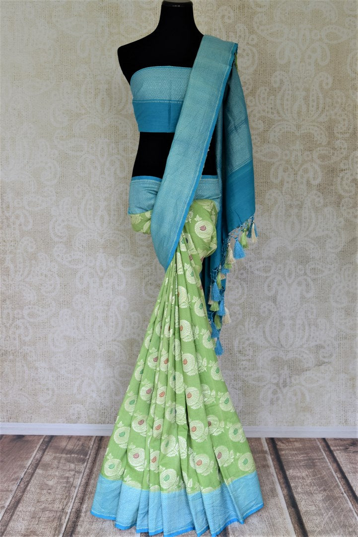 Shop light green muga Benarasi saree online in USA with blue zari border and marigold buta. Make your saree wardrobe rich and colorful with stunning handwoven sarees, pure silk sarees, designer sarees from Pure Elegance Indian clothing store in USA.-full view