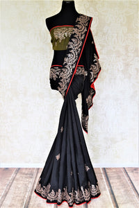 Shop stunning black silk saree online in USA with embroidered border. Be the center of attraction at weddings and parties with beautiful silk sarees, embroidered sarees, partywear sarees, fancy sarees from Pure Elegance Indian fashion store in USA. -full view