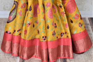 Shop charming yellow floral print tassar sari online in USA with pink zari border. Be the talk of the occasions in exquisite tassar sarees, handwoven silk saris from Pure Elegance Indian fashion store in USA. -pleats