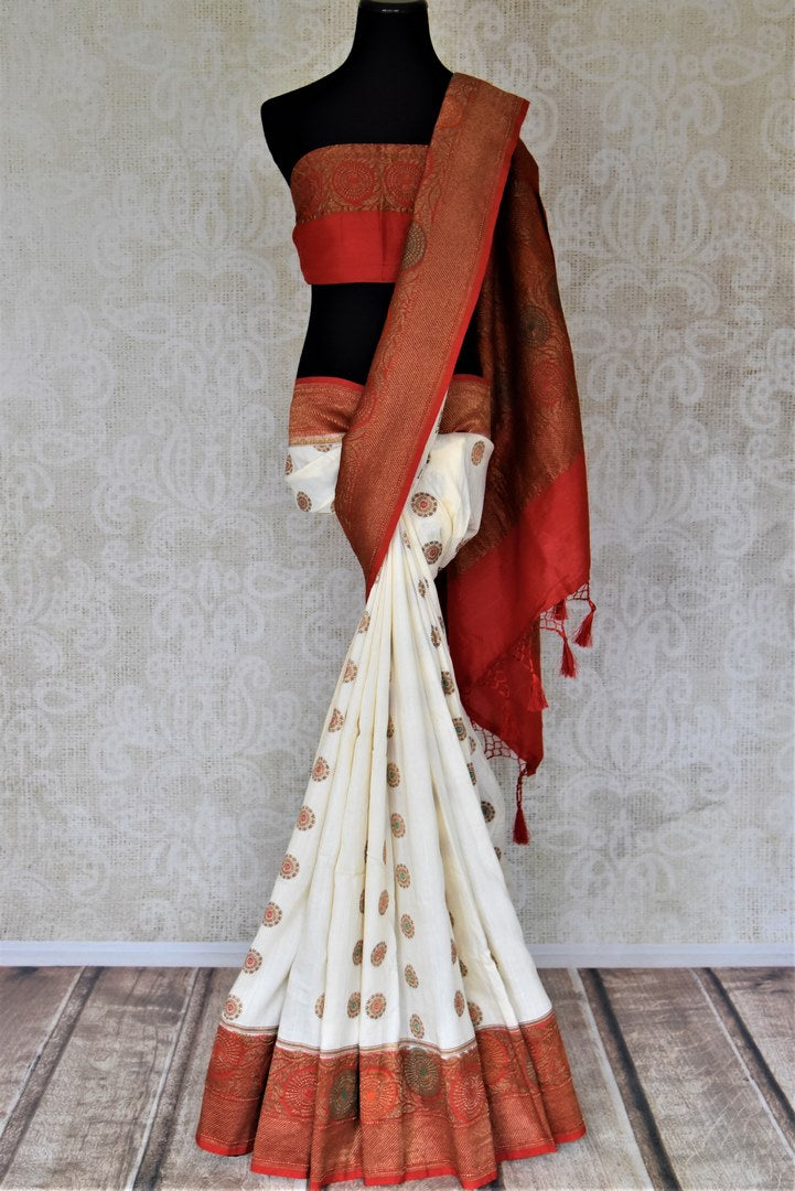 Buy off-white muga Banarasi sari online in USA with red antique zari floral border. Keep your ethnic style updated with latest designer sarees, handloom sarees, pure silk sarees from Pure Elegance Indian fashion store in USA.-full view
