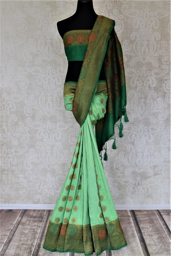 Buy pastel green muga Banarasi sari online in USA with dark green antique zari floral border. Keep your ethnic style updated with latest designer sarees, handloom sarees, pure silk sarees from Pure Elegance Indian fashion store in USA.-full view