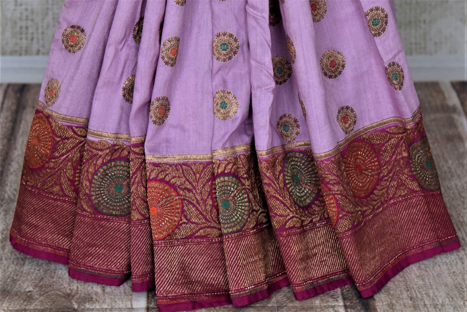 Shop lavender muga Banarasi saree online in USA with magenta antique zari floral border. Keep your ethnic style updated with latest designer sarees, handloom sarees, pure silk sarees from Pure Elegance Indian fashion store in USA.-pleats