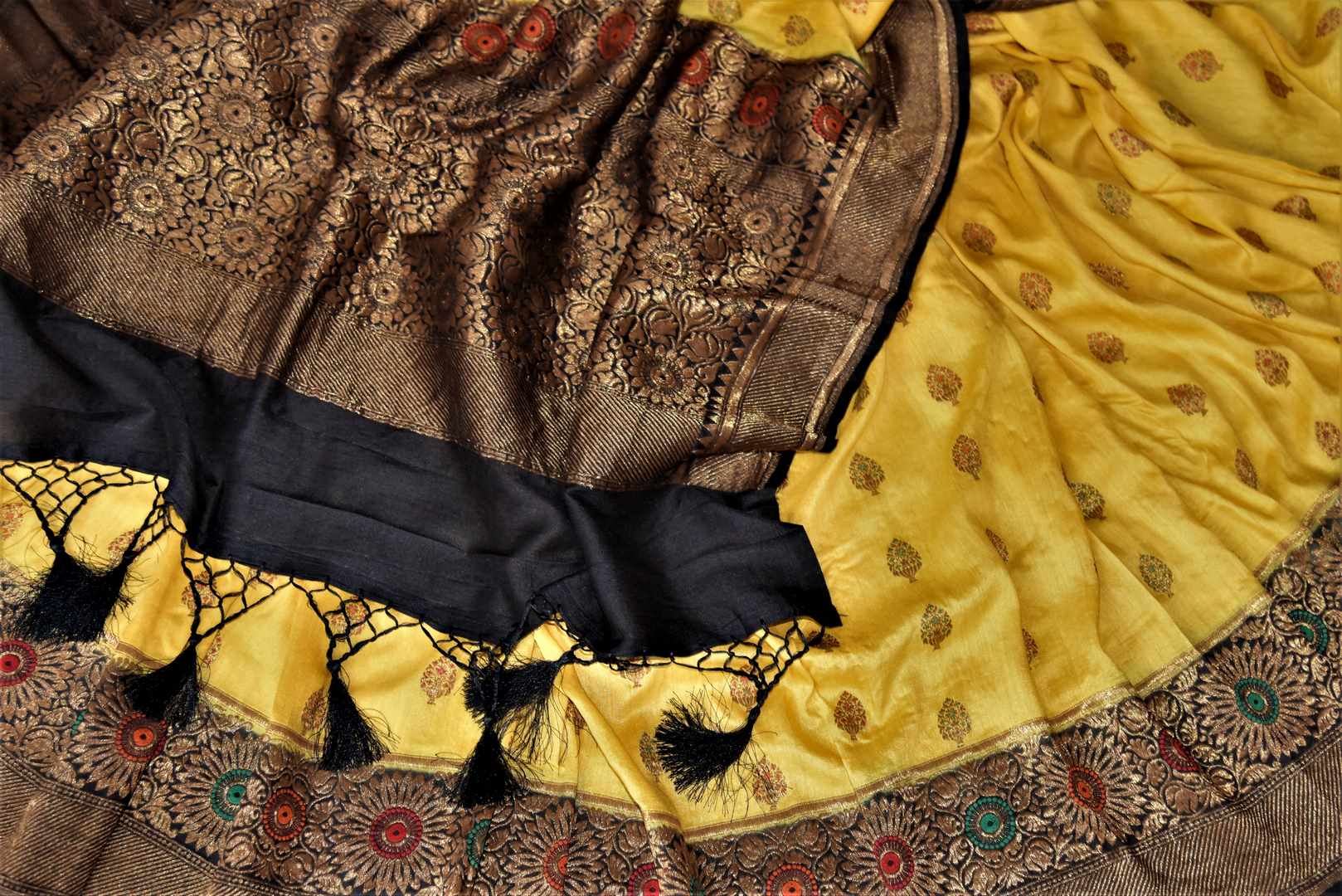 Shop stunning yellow muga Banarasi sari online in USA with black antique zari floral border. Keep your ethnic style updated with latest designer sarees, handloom sarees, pure silk sarees from Pure Elegance Indian fashion store in USA.-details