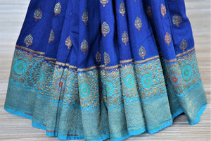 Shop indigo muga Banarasi sari online in USA with antique zari minakari blue border and buta. Be a vision of tradition and elegance on weddings and festivals with exquisite Banarasi silk sarees, muga silk sarees, handwoven sarees from Pure Elegance Indian clothing store in USA.-pleats
