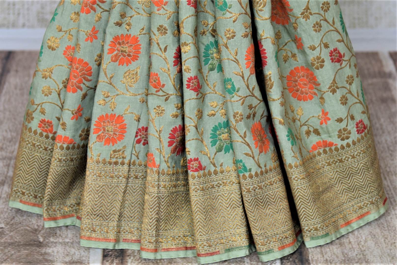 Shop beautiful sage green minakari weave Banarasi sari online in USA. Keep it light yet festive on special occasions with beautiful handwoven saris, Banarasi sarees from Pure Elegance Indian fashion store in USA.-pleats