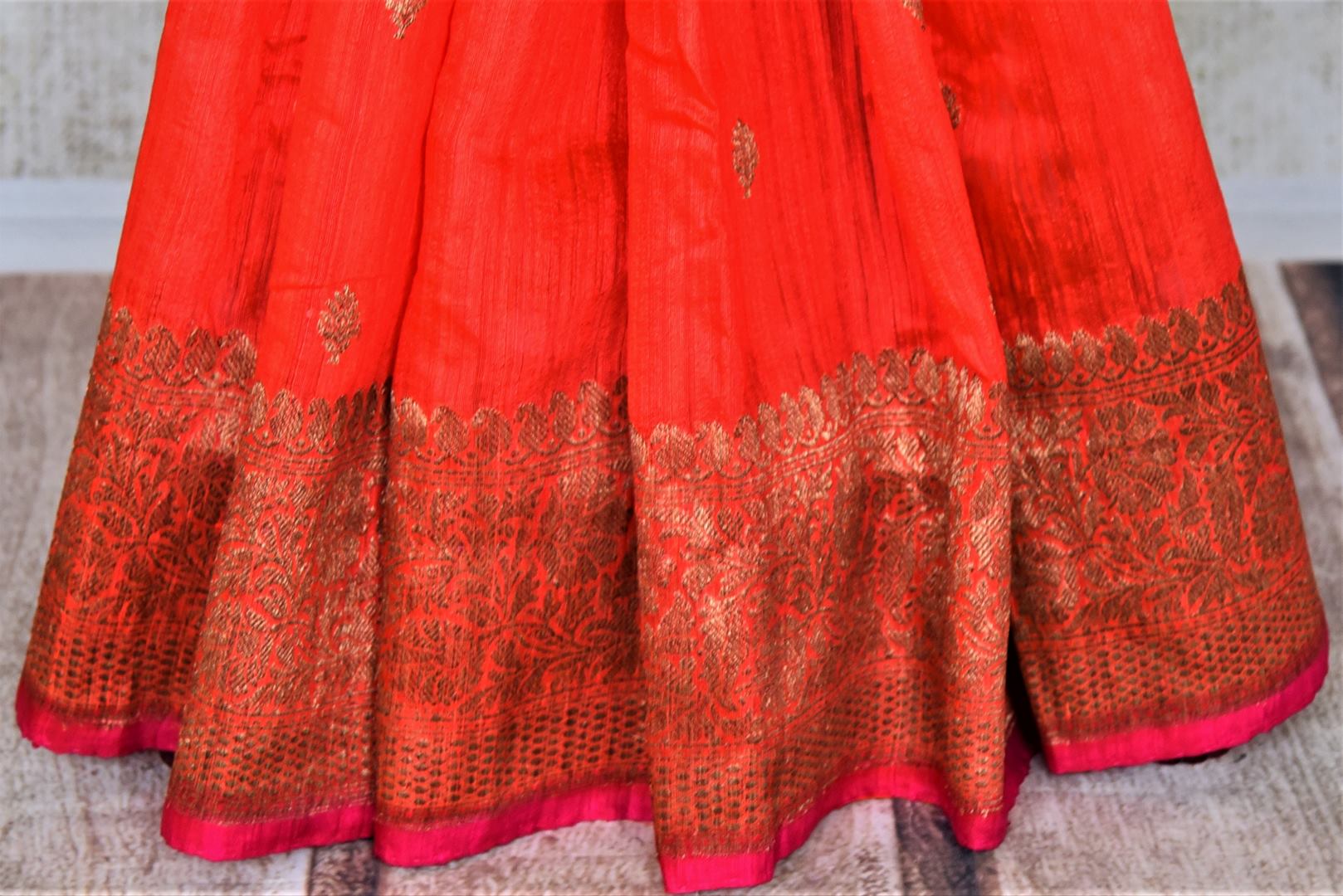 Buy bright red tussar Banarasi saree online in USA with zari buta and zari border. Choose tasteful handloom saris for special occasions from Pure Elegance. Our exclusive Indian fashion store has a myriad of exquisite pure silk saris, tussar sarees, Banarasi sarees for Indian women in USA.-pleats