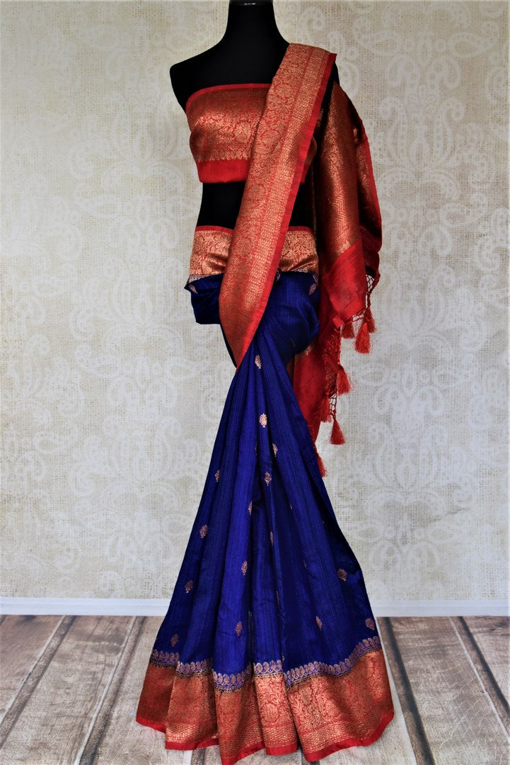 Shop indigo blue tussar Banarasi saree online in USA with zari buta and red antique zari border. Choose tasteful handloom saris for special occasions from Pure Elegance. Our exclusive Indian fashion store has a myriad of exquisite pure silk saris, tussar sarees, Banarasi sarees for Indian women in USA.-full view