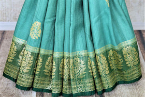 Buy beautiful sea green tussar Banarsi saree online in USA with floral zari buta border. Be the center of attraction at parties and weddings with beautiful Kanchipuram silk sarees, pure silk sarees, handwoven sarees, Banarasi sarees from Pure Elegance Indian fashion store in USA.-pleats