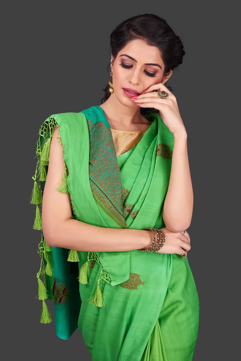 Shop alluring ombre green borderless muga Banarasi saree online in USA with antique zari buta. Shop beautiful Banarasi sarees, pure muga silk sarees in USA from Pure Elegance Indian fashion boutique in USA. Get spoiled for choices with a splendid variety of Indian saris to choose from! Shop now.-closeup