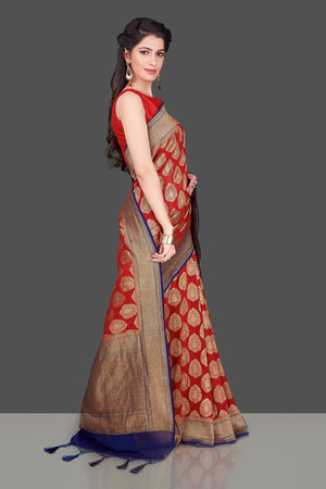 Buy bright red georgette Banarasi sari online in USA with blue zari border. Shop beautiful Banarasi sarees, georgette sarees, pure muga silk sarees in USA from Pure Elegance Indian fashion boutique in USA. Get spoiled for choices with a splendid variety of Indian saris to choose from! Shop now.-side