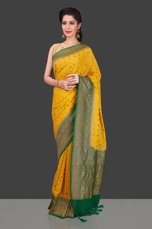Buy beautiful yellow georgette Benarasi saree online in USA with green zari border. Shop beautiful Banarasi sarees, georgette sarees, pure muga silk sarees in USA from Pure Elegance Indian fashion boutique in USA. Get spoiled for choices with a splendid variety of Indian saris to choose from! Shop now.-front