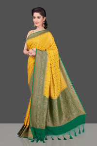 Buy beautiful yellow georgette Benarasi saree online in USA with green zari border. Shop beautiful Banarasi sarees, georgette sarees, pure muga silk sarees in USA from Pure Elegance Indian fashion boutique in USA. Get spoiled for choices with a splendid variety of Indian saris to choose from! Shop now.-full view