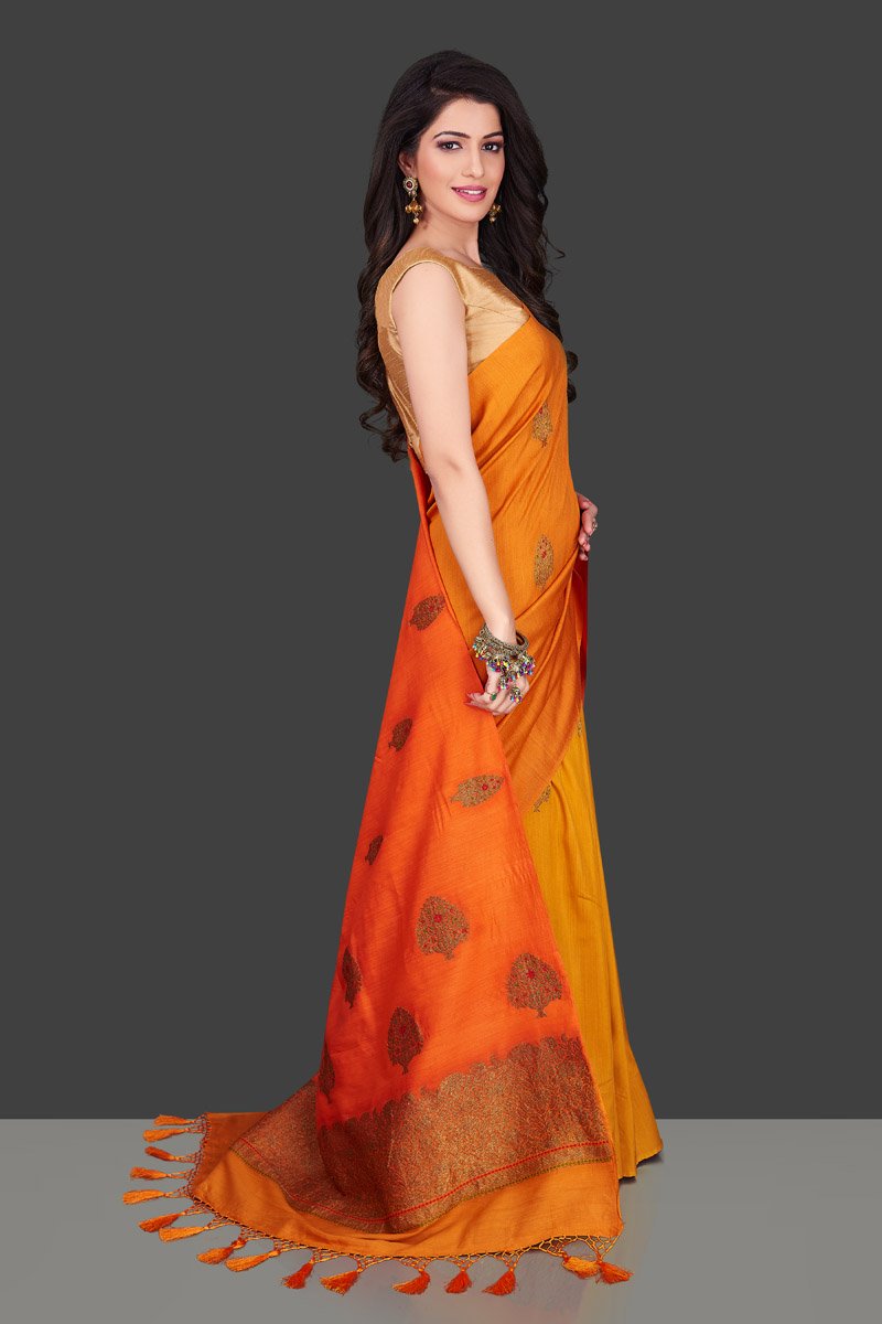 Buy charming orange and yellow borderless muga Benarasi sari online in USA with antique zari buta. Shop beautiful Banarasi sarees, georgette sarees, pure muga silk sarees in USA from Pure Elegance Indian fashion boutique in USA. Get spoiled for choices with a splendid variety of Indian saris to choose from! Shop now.-side