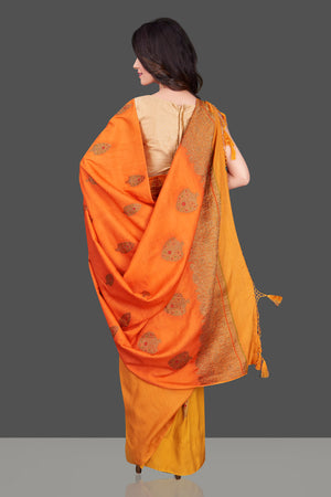 Buy charming orange and yellow borderless muga Benarasi sari online in USA with antique zari buta. Shop beautiful Banarasi sarees, georgette sarees, pure muga silk sarees in USA from Pure Elegance Indian fashion boutique in USA. Get spoiled for choices with a splendid variety of Indian saris to choose from! Shop now.-back