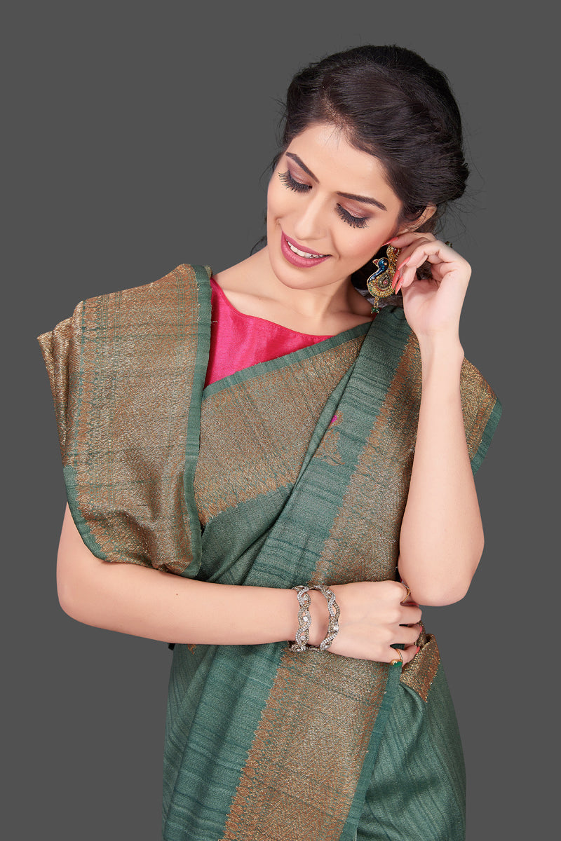 Shop elegant green tussar Banarasi sari online in USA with antique zari minakari buta. Shop beautiful Banarasi sarees, tussar sarees, pure muga silk sarees in USA from Pure Elegance Indian fashion boutique in USA. Get spoiled for choices with a splendid variety of Indian saris to choose from! Shop now.-closeup