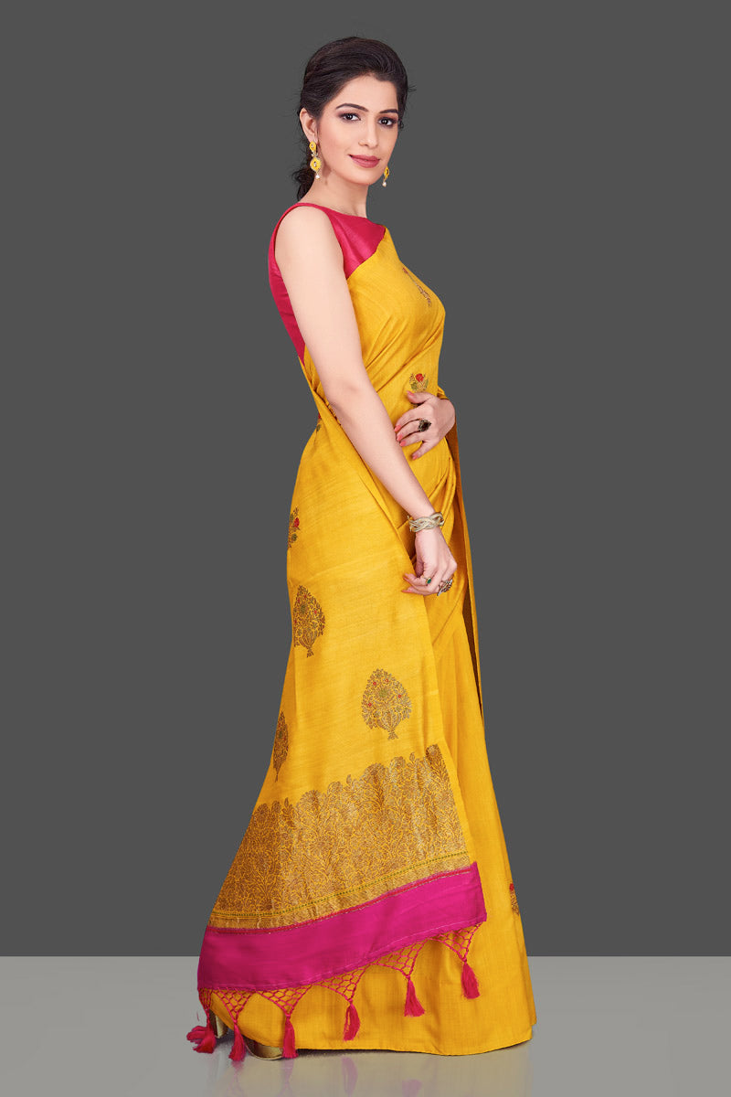 Buy gorgeous yellow borderless muga Banarasi saree online in USA with floral bunch zari buta. Shop beautiful Banarasi sarees, georgette sarees, pure muga silk sarees in USA from Pure Elegance Indian fashion boutique in USA. Get spoiled for choices with a splendid variety of Indian saris to choose from! Shop now.-side