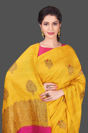 Buy gorgeous yellow borderless muga Banarasi saree online in USA with floral bunch zari buta. Shop beautiful Banarasi sarees, georgette sarees, pure muga silk sarees in USA from Pure Elegance Indian fashion boutique in USA. Get spoiled for choices with a splendid variety of Indian saris to choose from! Shop now.-front