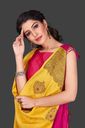 Buy bright yellow borderless muga Banarasi saree online in USA with zari buta. Shop beautiful Banarasi sarees, georgette sarees, pure muga silk sarees in USA from Pure Elegance Indian fashion boutique in USA. Get spoiled for choices with a splendid variety of Indian saris to choose from! Shop now.-closeup