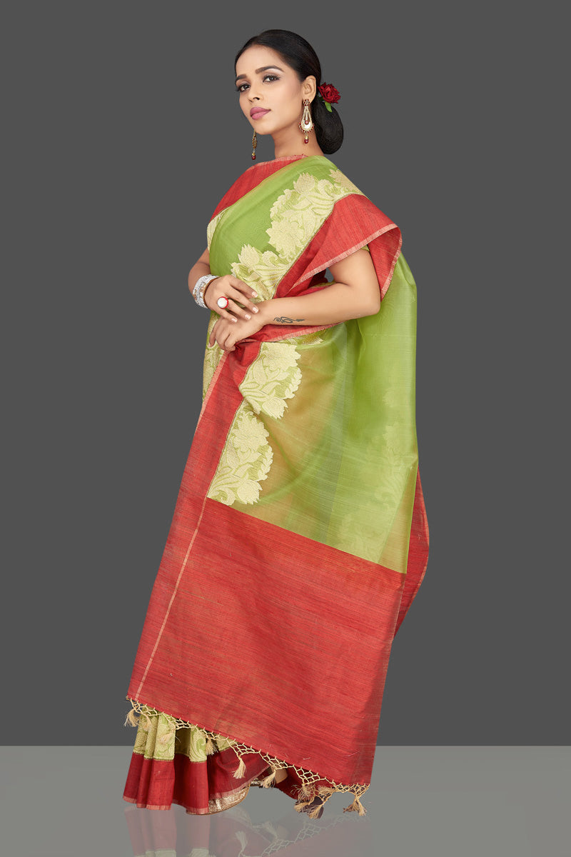 Buy green organza Banarasi saree online in USA with zari work on red border. Be the center of attraction at weddings and parties with your captivating ethnic style in beautiful Banarsi silk saris. tanchoi sarees from Pure Elegance Indian fashion store in USA.-left