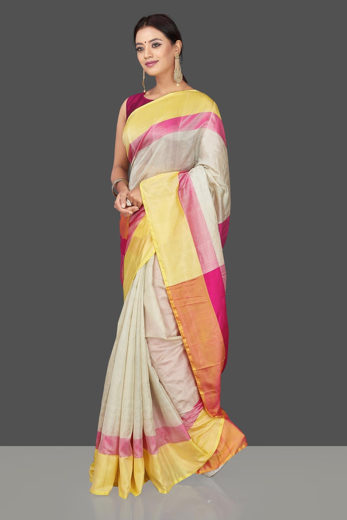 Buy beautiful off-white  Uppada silk saree online in USA with pink and yellow border. Keep it elegant with handwoven silk sarees, Uppada silk sarees from Pure Elegance Indian fashion boutique in USA.-left