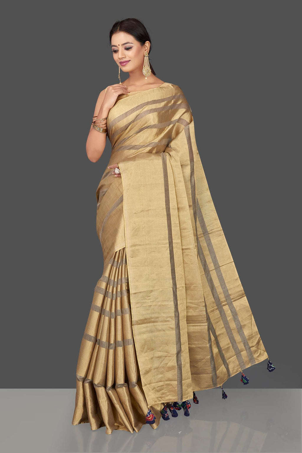 Shop golden tissue tassar saree online in USA with blue tassels on pallu. Keep it elegant with handwoven saris, Tassar silk sarees, tissue sarees from Pure Elegance Indian fashion boutique in USA. We bring a especially curated collection of ethnic sarees for Indian women in USA under one roof!-full view
