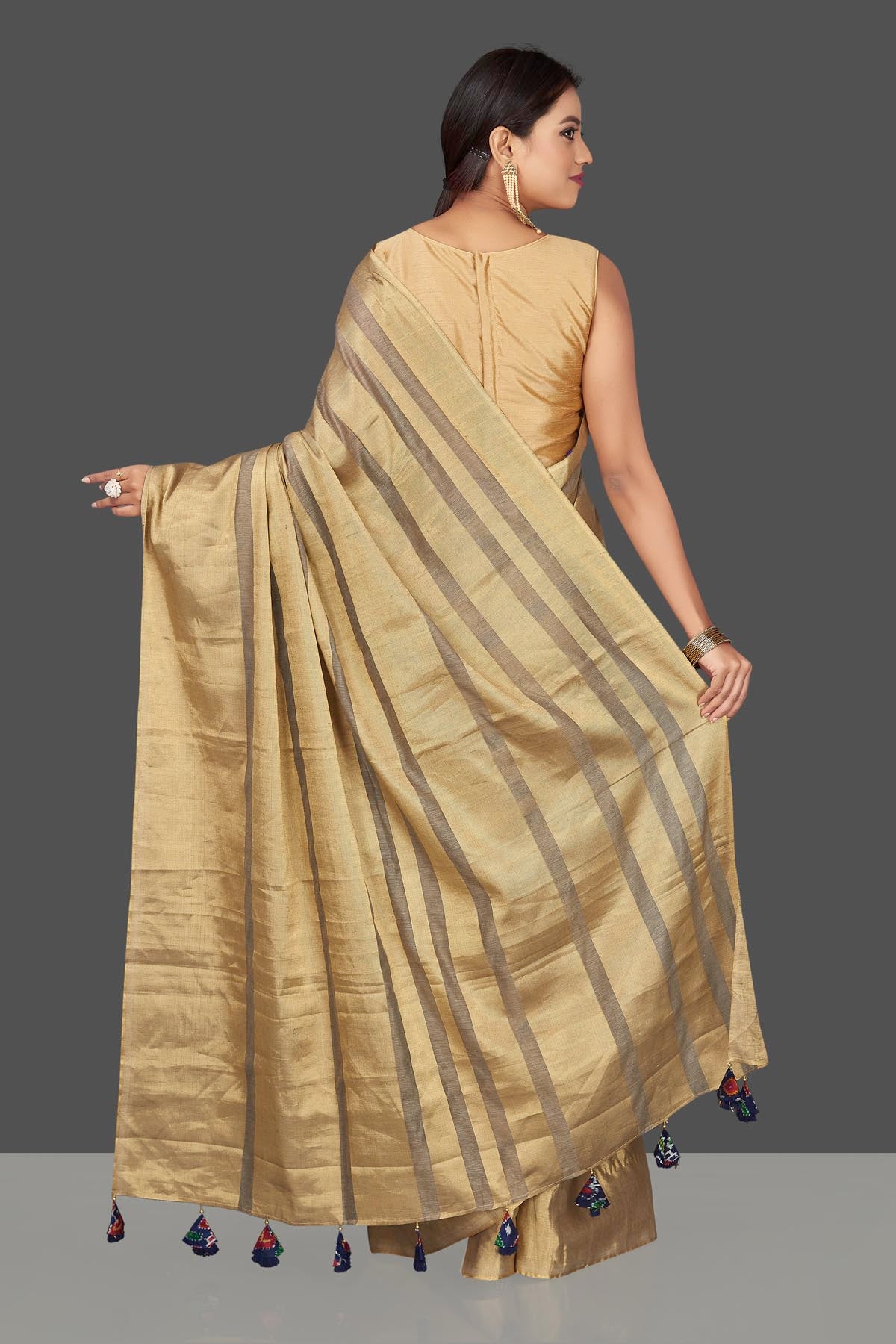 Shop golden tissue tassar saree online in USA with blue tassels on pallu. Keep it elegant with handwoven saris, Tassar silk sarees, tissue sarees from Pure Elegance Indian fashion boutique in USA. We bring a especially curated collection of ethnic sarees for Indian women in USA under one roof!-back