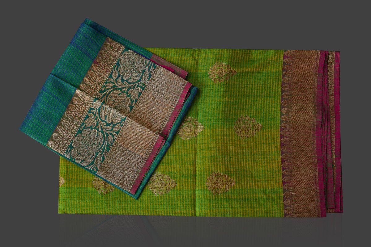 Buy light green tassar Banarasi saree online in USA with antique zari sea green border and zari buta. Garner compliments on weddings and special occasions with exquisite Banarasi saris, handwoven silk sarees, tussar sarees from Pure Elegance Indian fashion store in USA.-flatlay