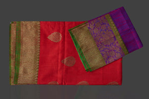 Shop stunning reddish orange tussar Banarasi sari online in USA with pink zari border. Garner compliments on weddings and special occasions with exquisite Banarasi saris, handwoven silk sarees, tussar sarees from Pure Elegance Indian fashion store in USA.-flatlay